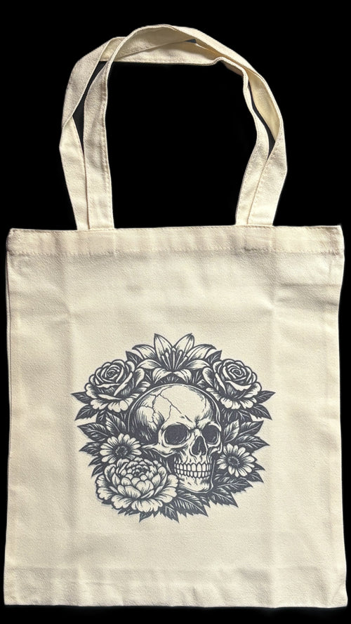 Tote bag with a skull and floral design on a black background