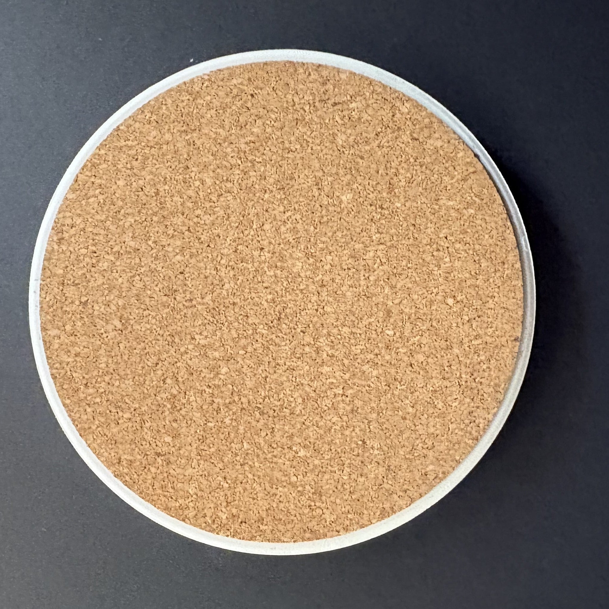 Round cork board on a dark background