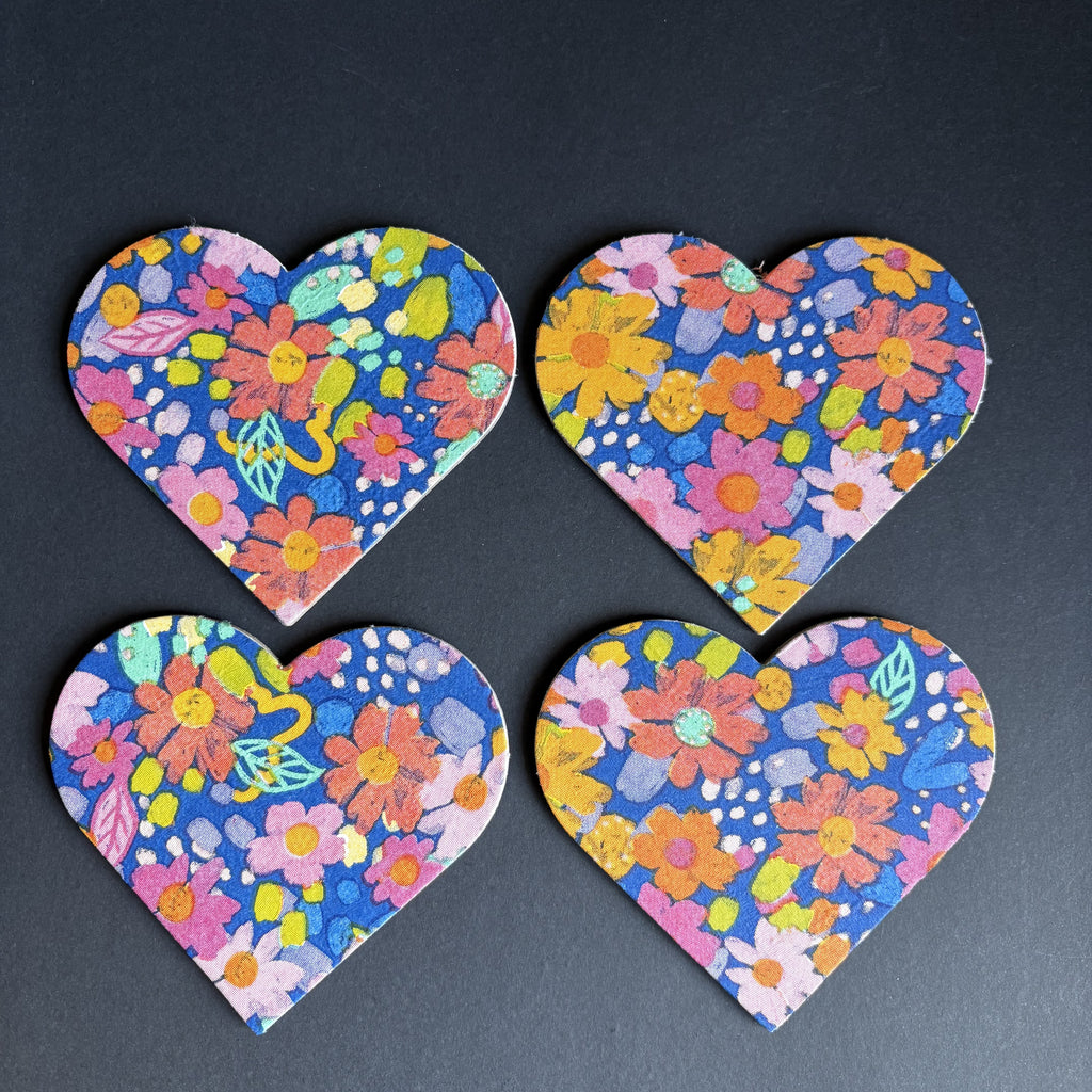 Four heart floral magnets with a colorful spring flower pattern