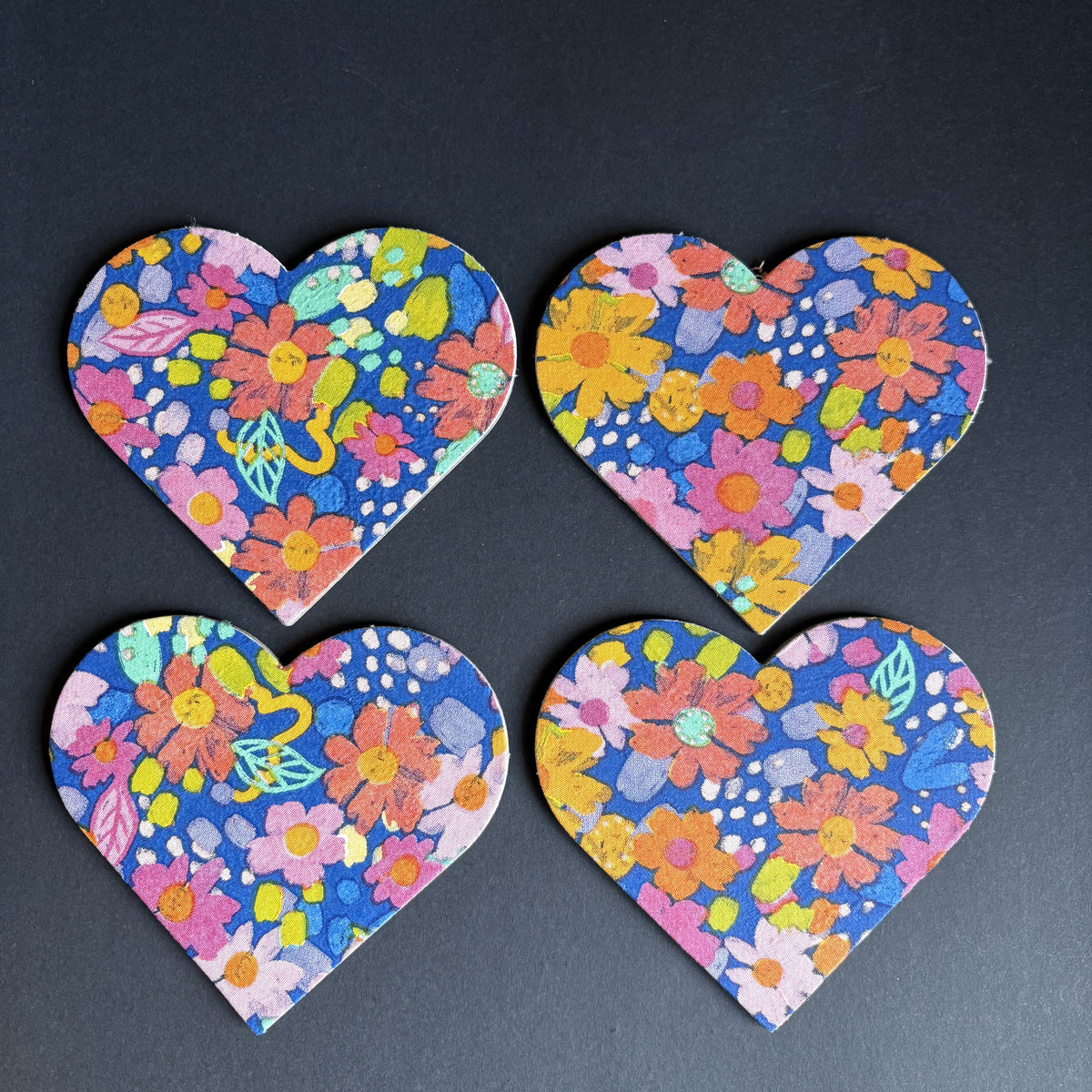 Four heart floral magnets with a colorful spring flower pattern