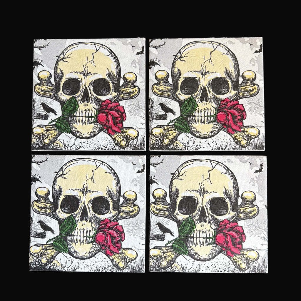 Four square magnets arranged in a 2x2 grid on a dark background, each featuring a distressed skull and crossbones design with a red rose and green leaves.