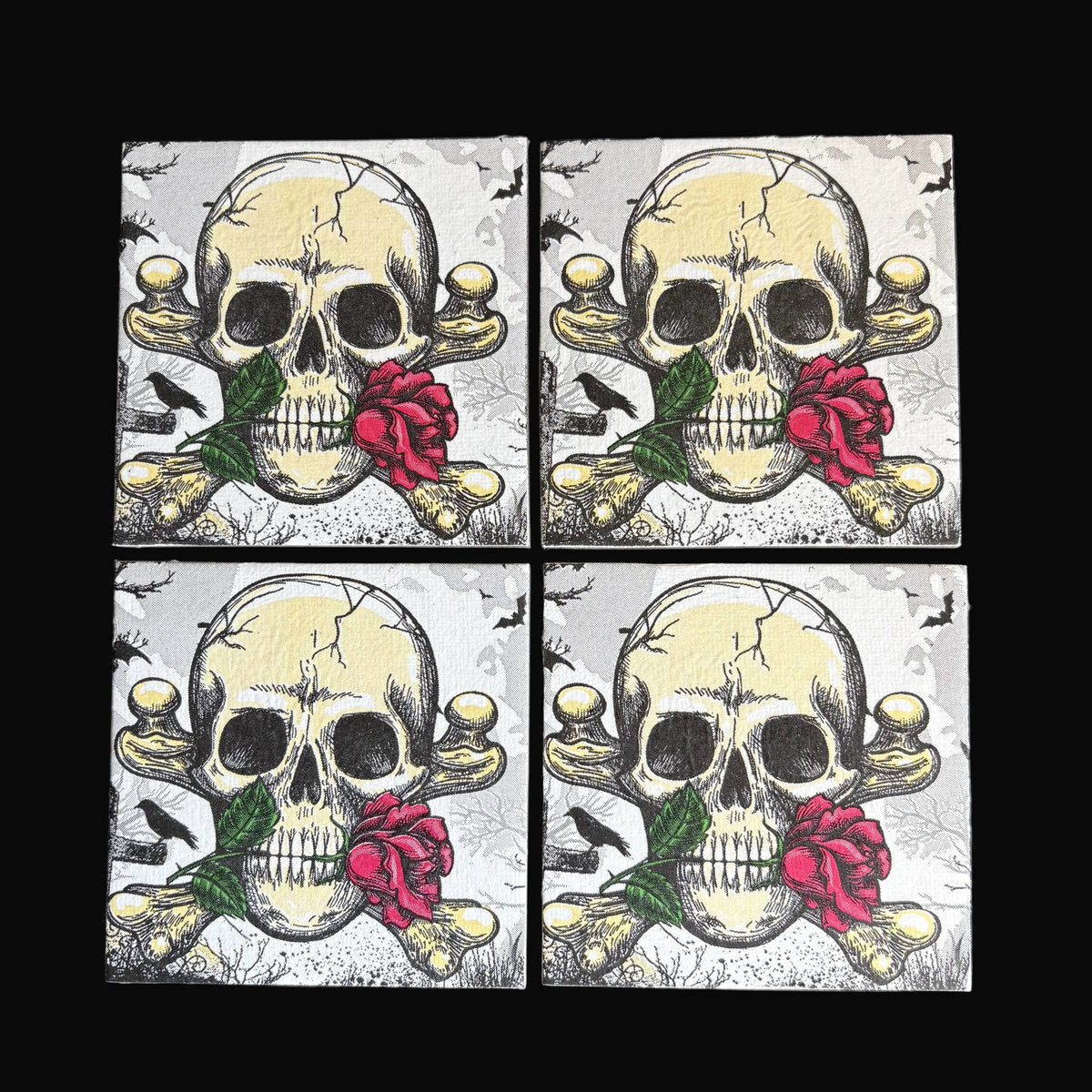 Four square magnets arranged in a 2x2 grid on a dark background, each featuring a distressed skull and crossbones design with a red rose and green leaves.