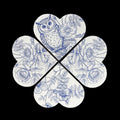 Four interlocking clover-shaped magnets with a blue floral and owl pattern on a white background, set against a solid black backdrop.