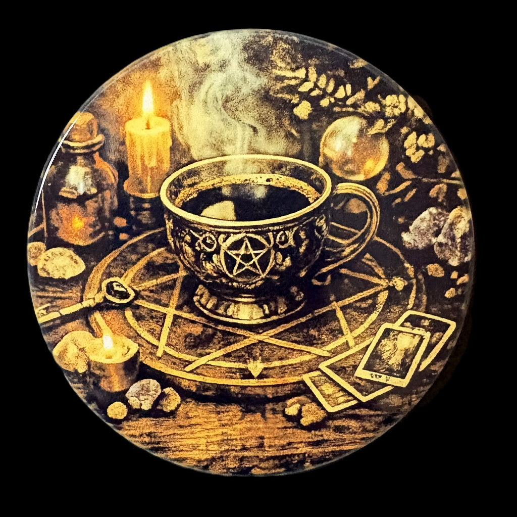 Decorative plate with a cup, candles, and tarot cards on a dark background