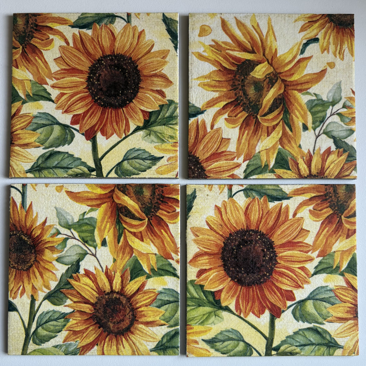Four sunflower-themed Magnets tiles on a white background