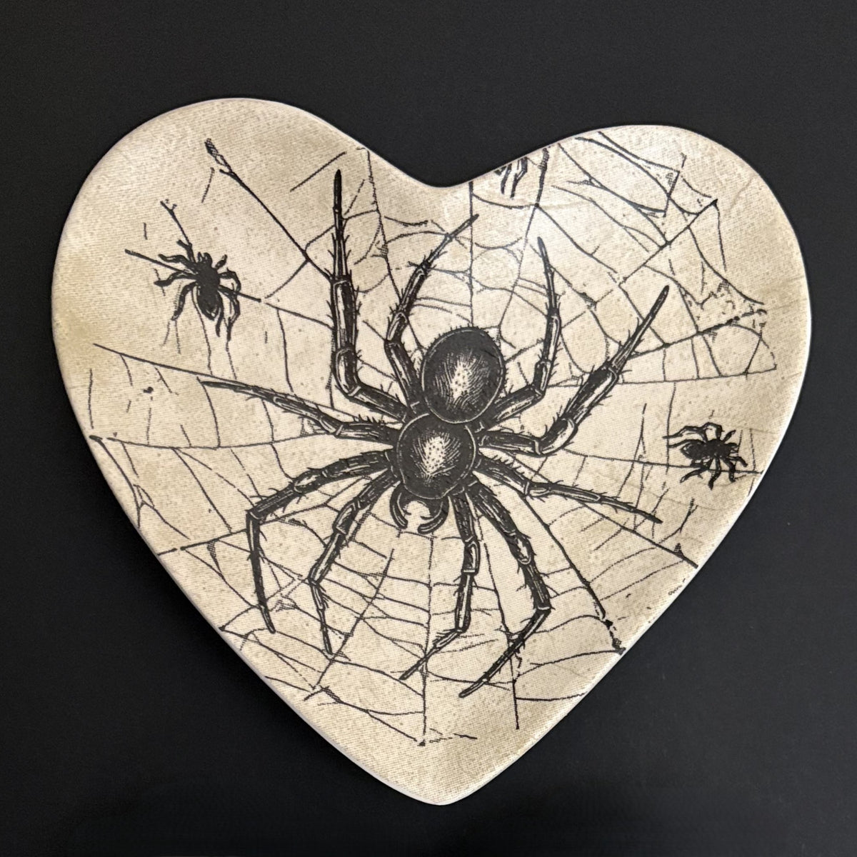 Ceramic trinket tray featuring an intricate gothic spider web illustration