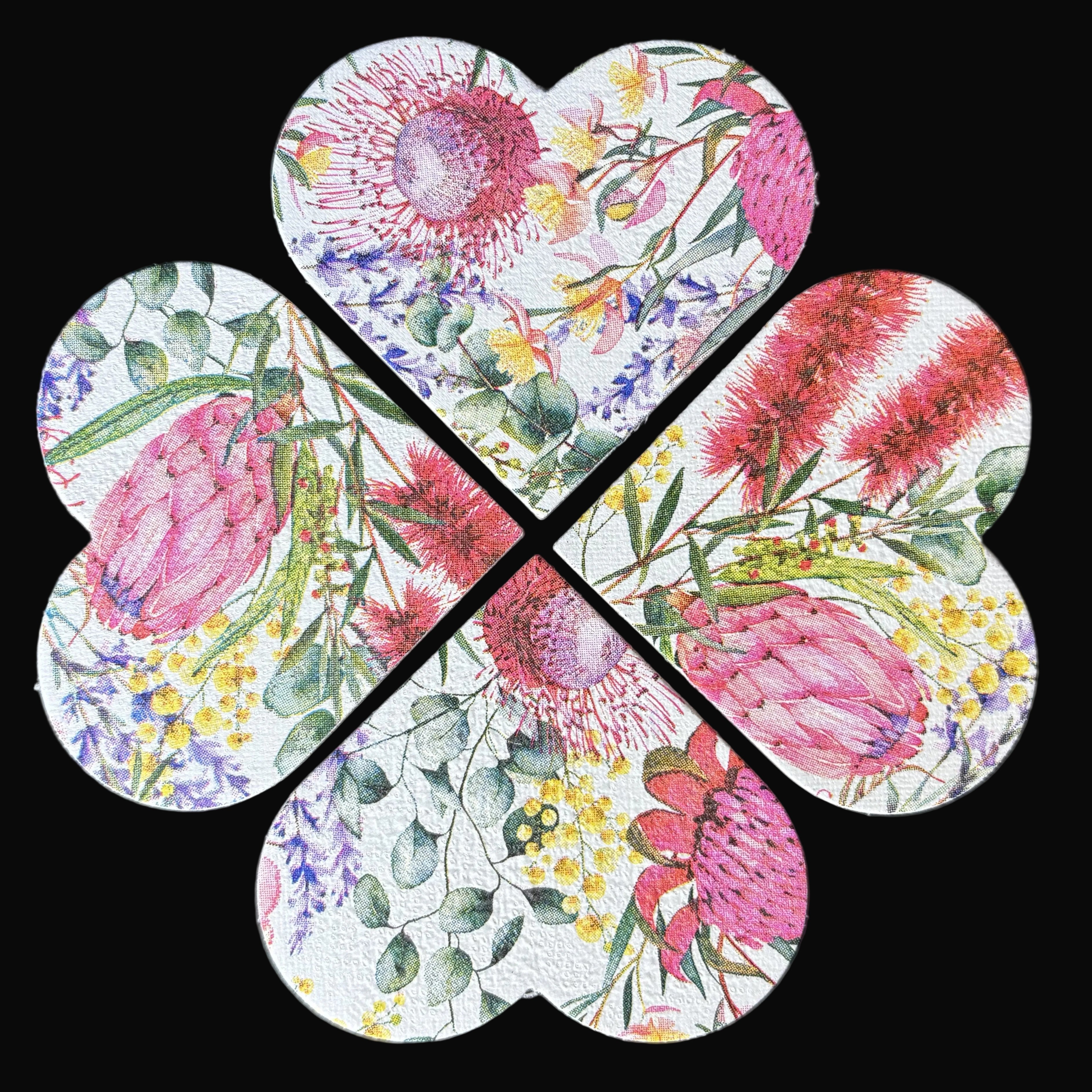 Four heart-shaped magnets arranged in a flower pattern on a dark background, featuring a colorful watercolor floral print with pink protea-like flowers, green leaves, and yellow blossoms.