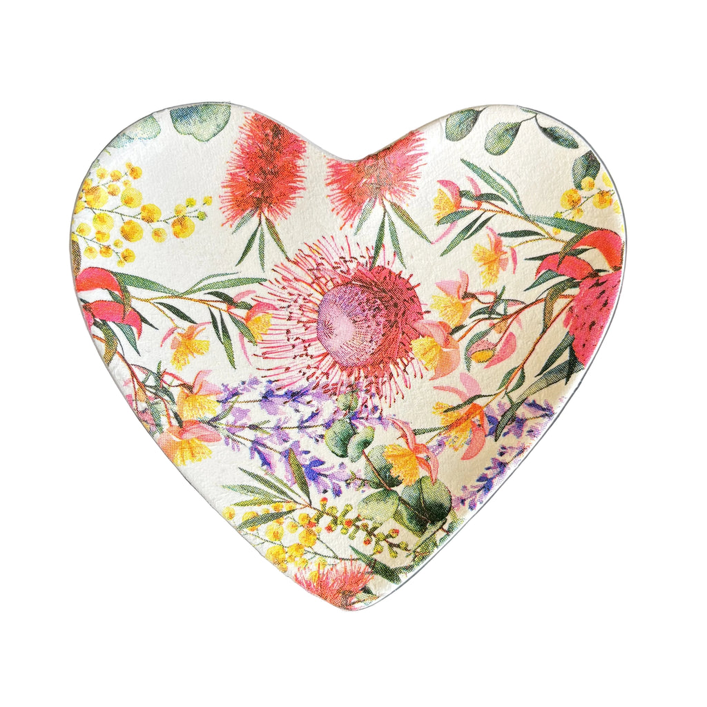 A heart-shaped ceramic trinket tray featuring a vibrant, multicolor botanical and floral print with red, pink, yellow, and purple flowers on a cream background.