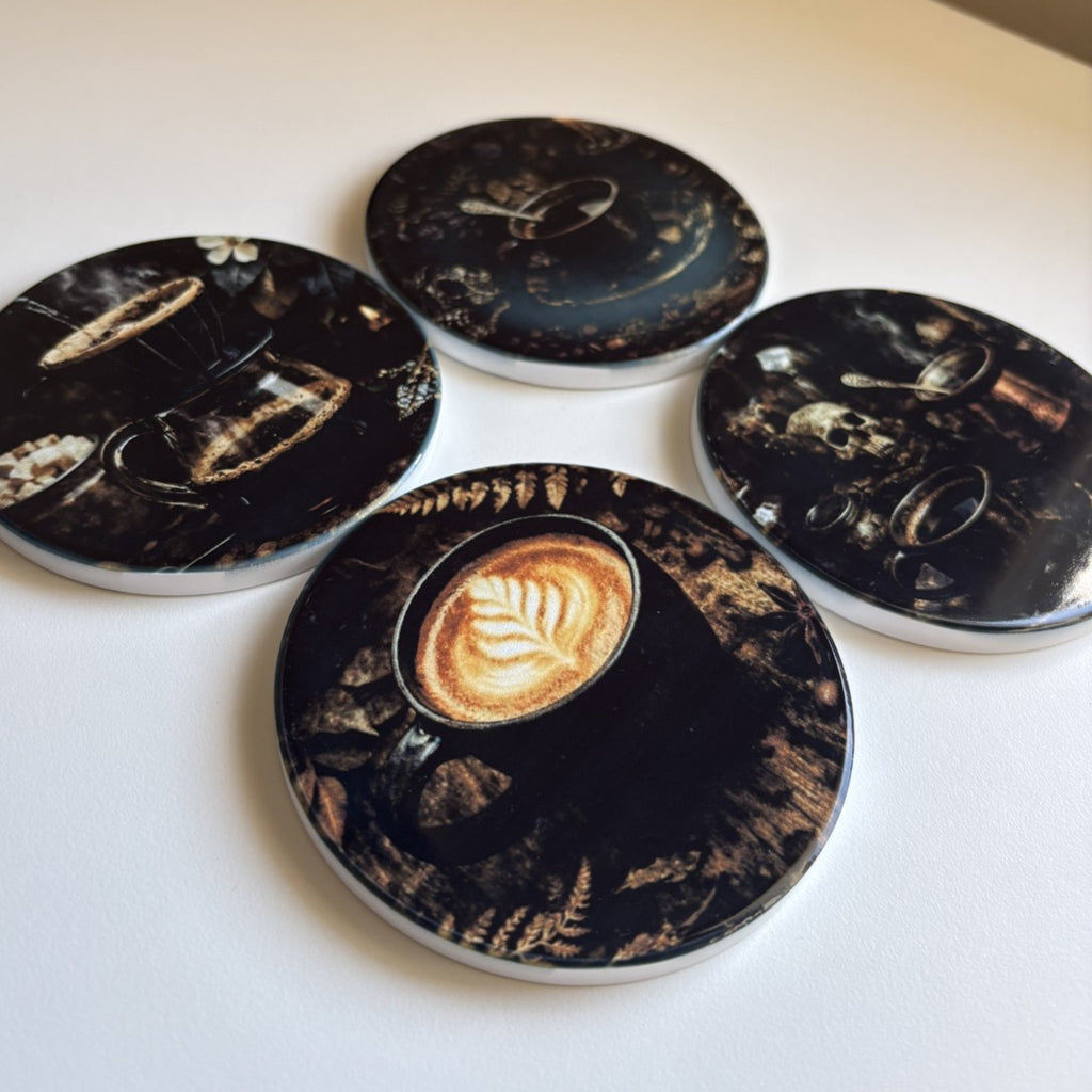 Four round coasters with a dark coffee-themed print featuring coffee cups, steam, and latte art, arranged on a plain white surface.
