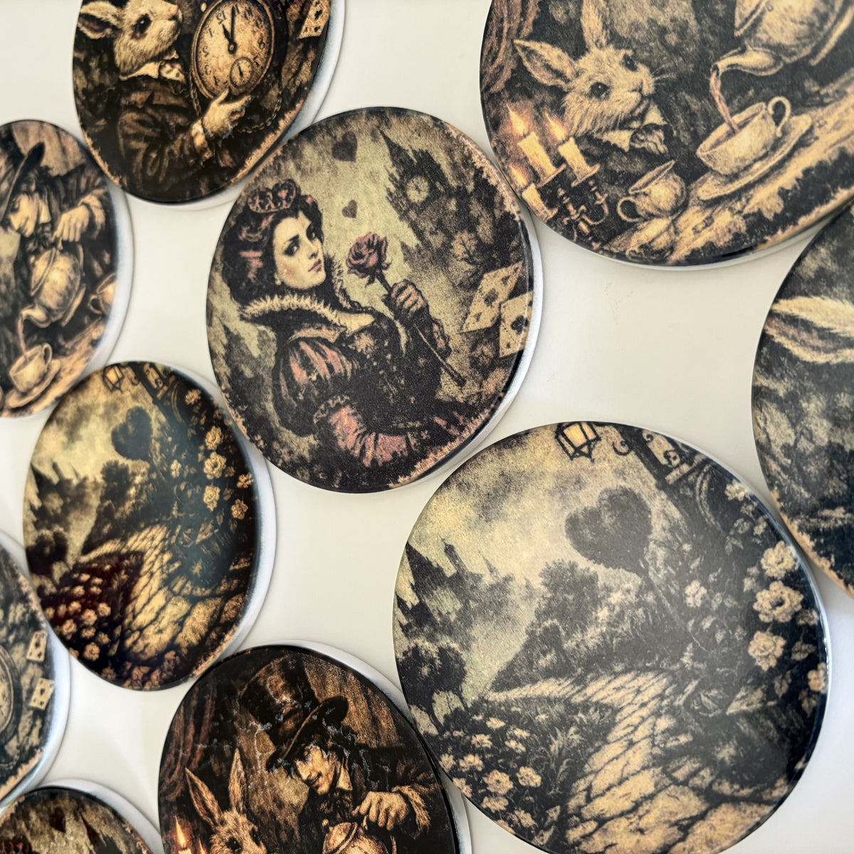 A collection of round decorative coasters with vintage-style illustrated designs, featuring sepia-toned scenes and characters on a white background.