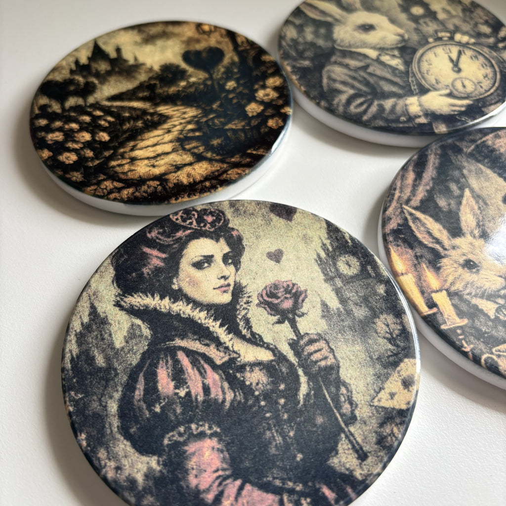 Four round coasters with vintage-style black and sepia illustrations of rabbits, a clock, a woman and rabbit, and a landscape path.