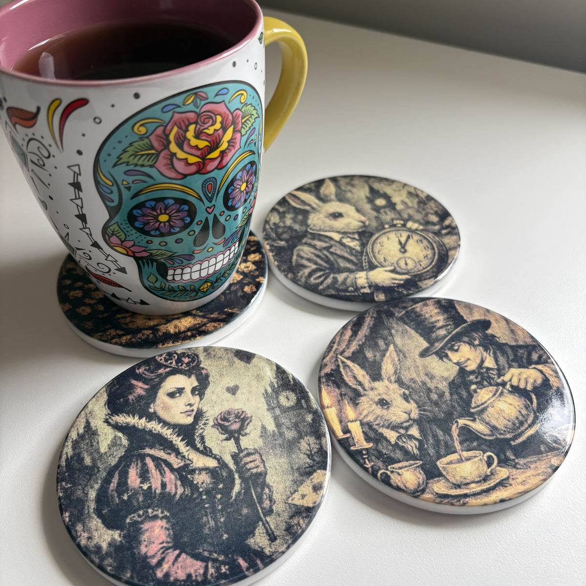 Four round coasters with vintage-style black and sepia illustrations with coffee mug
