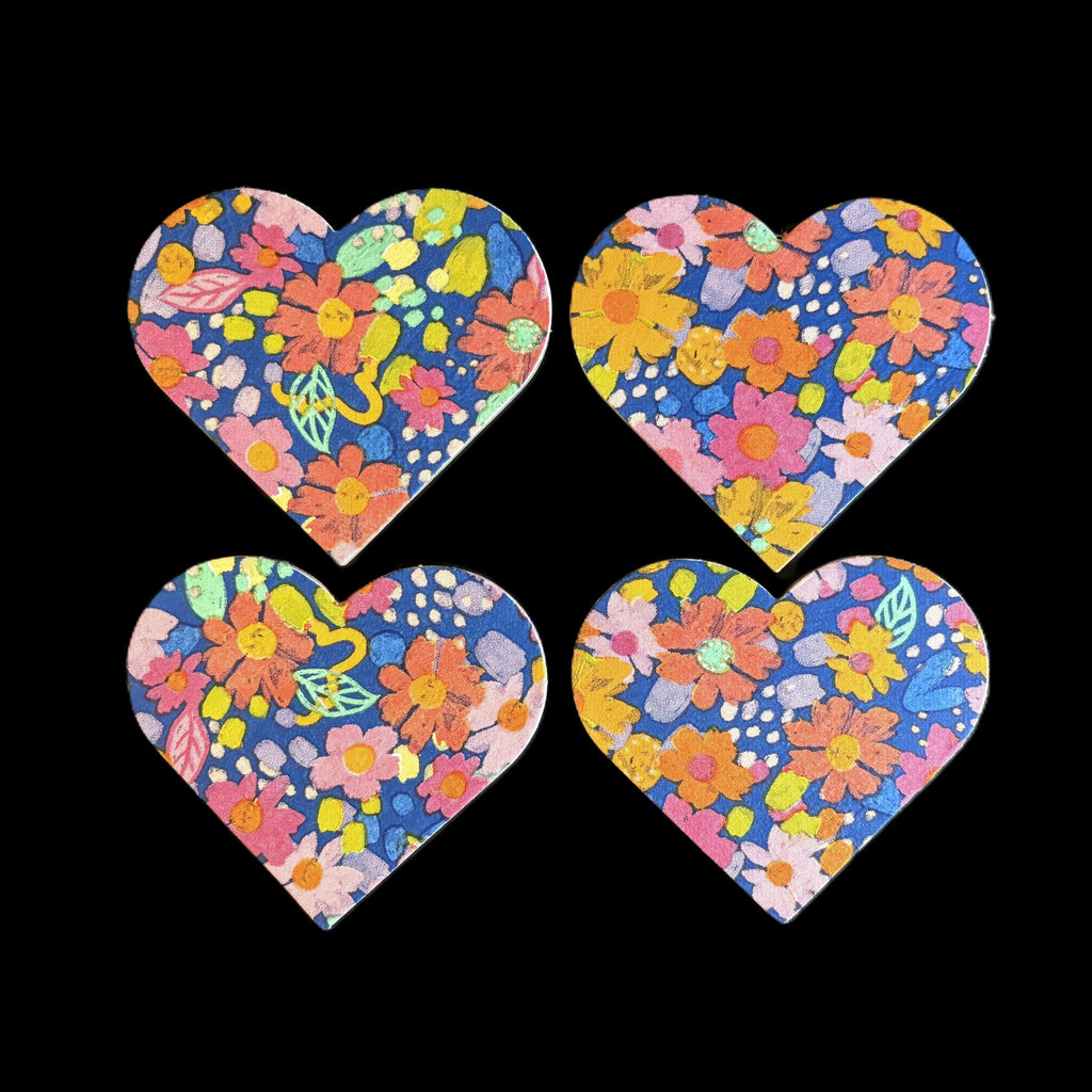 Four heart floral magnets with a colorful spring flower pattern on black background